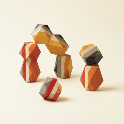 PlanToys set of wooden stacking stones in earthy colors on a plain cream background