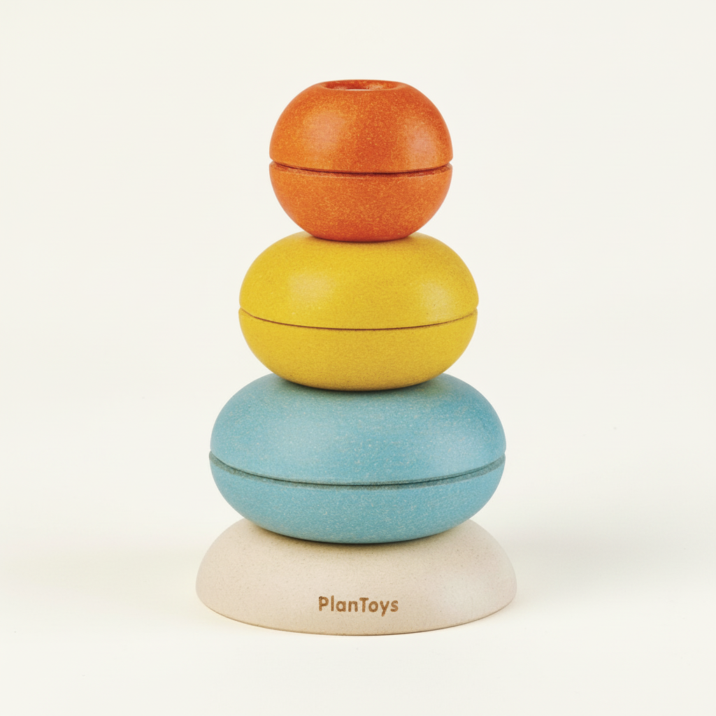 PlanToys set of wooden stacking ring cups on a plain cream background